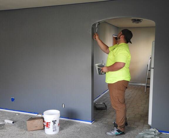 One of our professional painters adding final touches to an interior arch