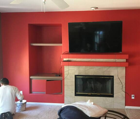 painting a living room wall around a fireplace 