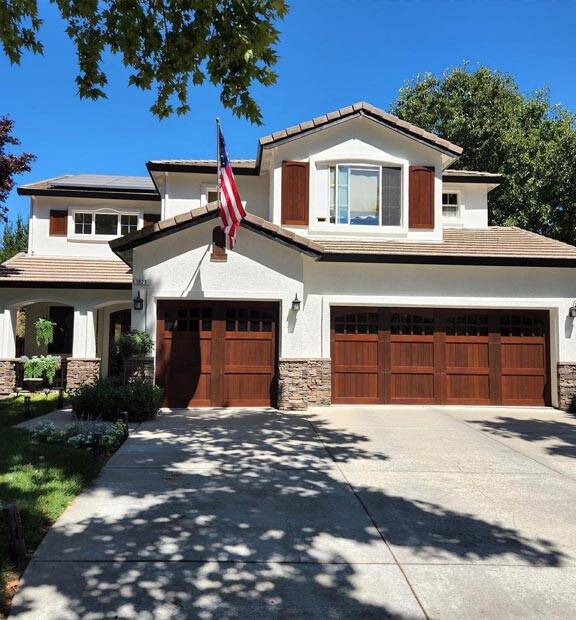 bone white exterior paint with stained garage doors