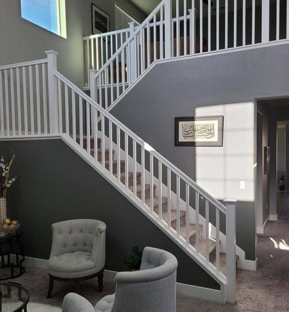 successful interior painting project: slate grey stairs with a pearl white banister